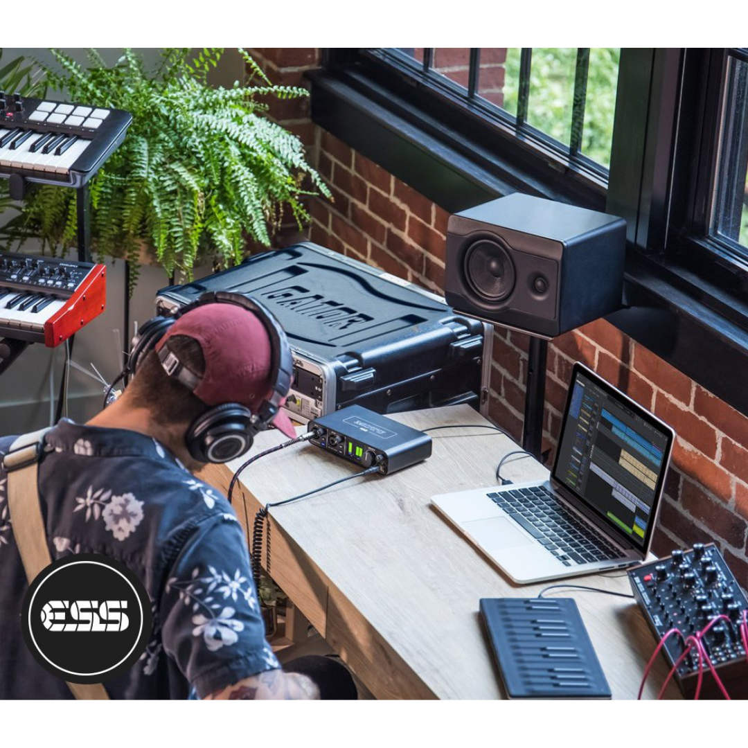 MOTU M2 Audio Interface in Home Studio with Music Producer, Headphones, MIDI Keyboard and Studio Monitor