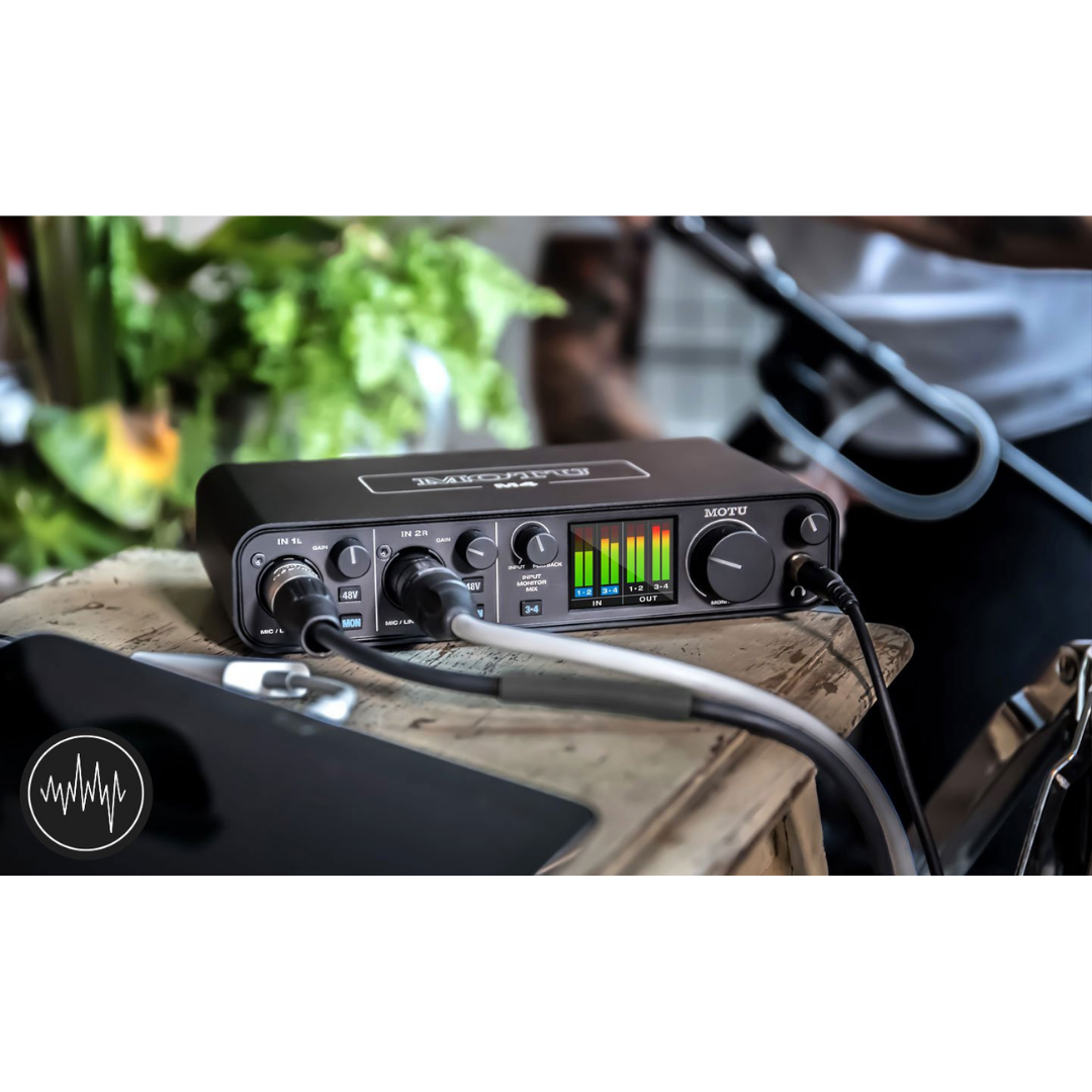MOTU M4 Audio Interface on Wooden Desktop with USB-C Cable Connected for Studio Recording