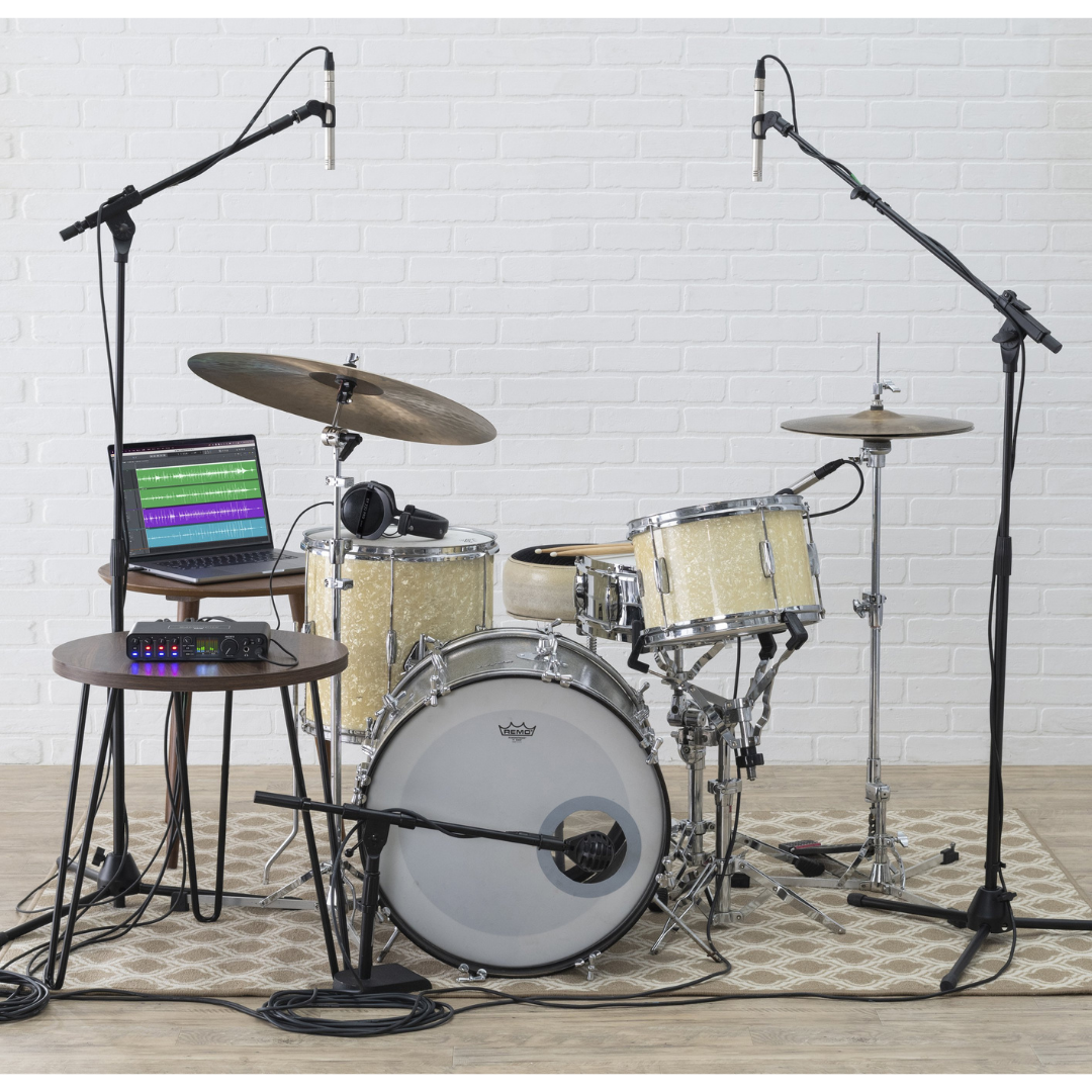 MOTU M6 Audio Interface in drum recording setup with overhead mics, laptop DAW and mic stands for studio recording